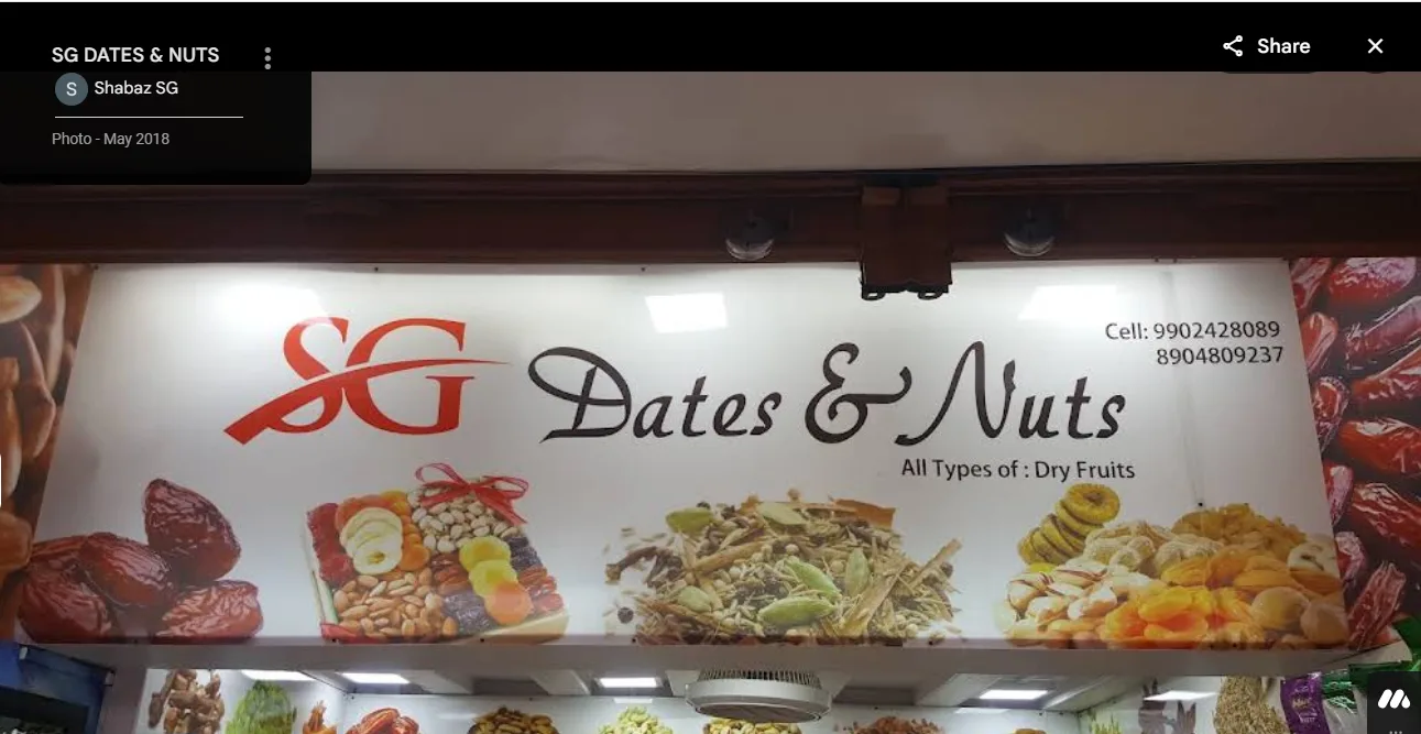SG Dates & Nuts shop signboard advertising all types of dry fruits in Belagavi