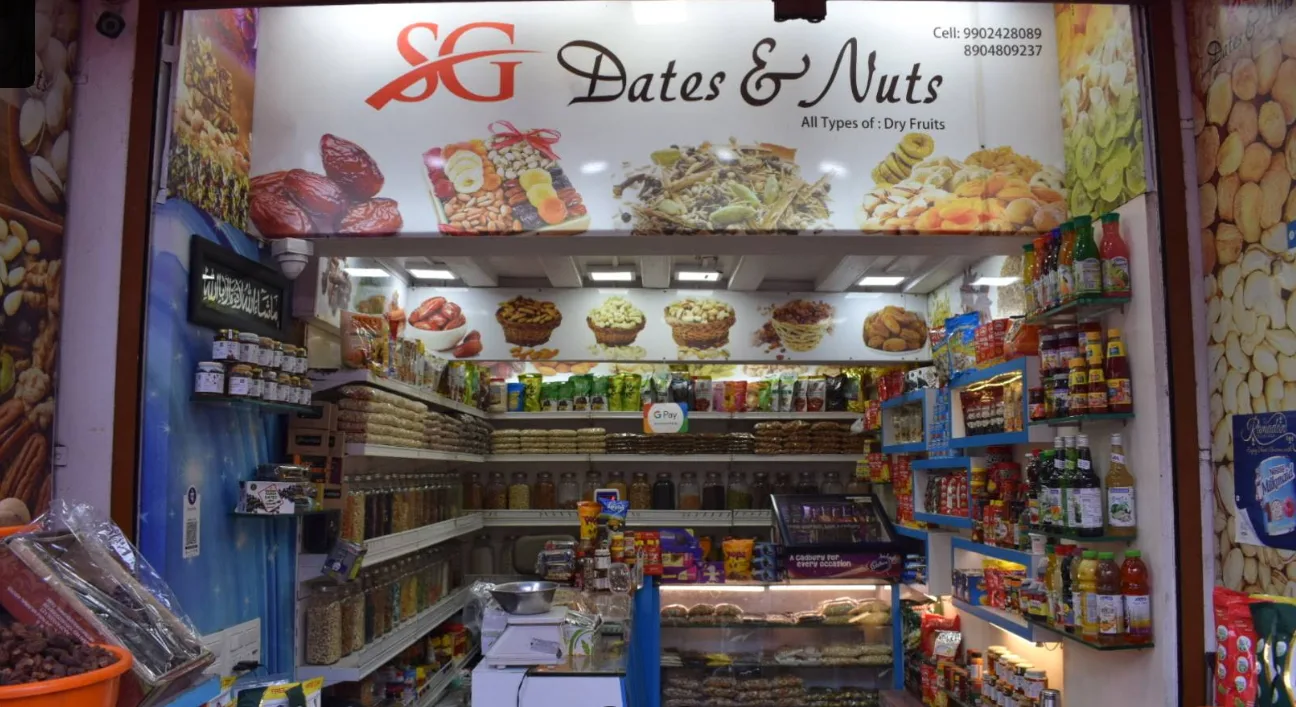Interior of the SG Dates & Nuts store in Chavi Market, Belagavi, with shelves of dry fruits